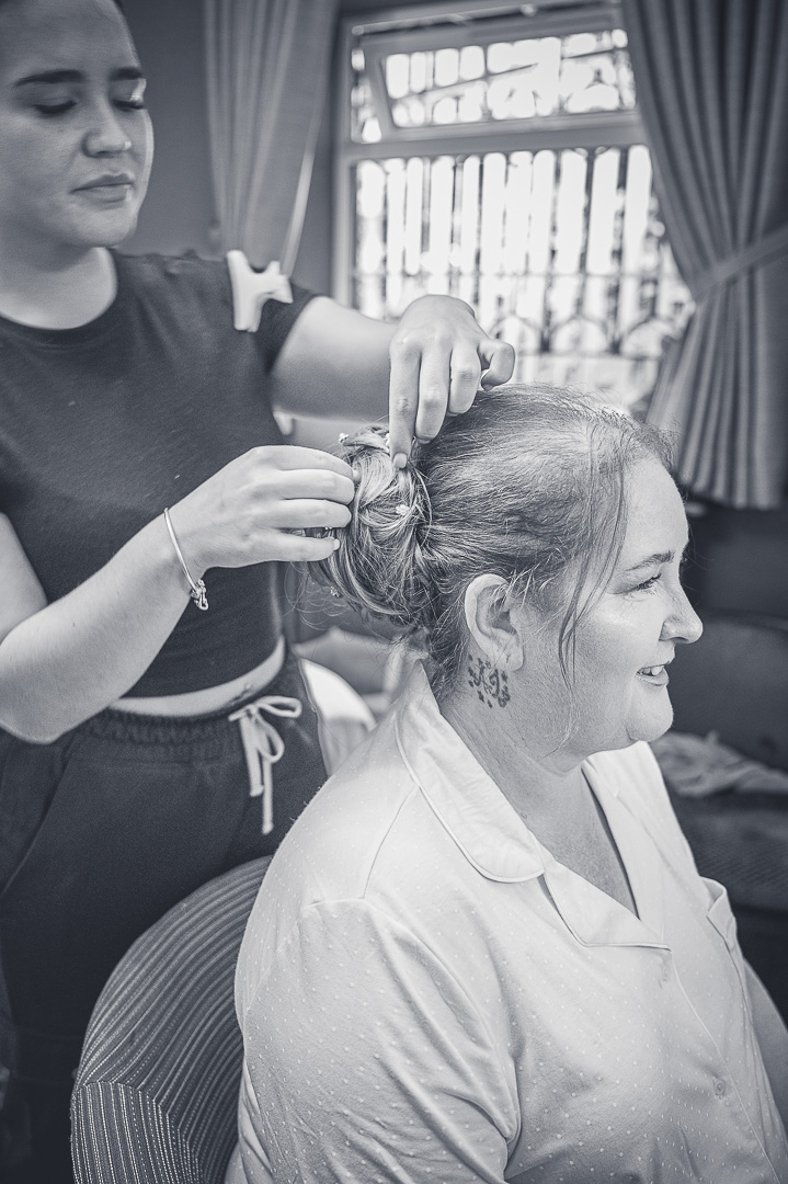 Bride having her hair carefully pinned into place at the Royal Toby Hotel