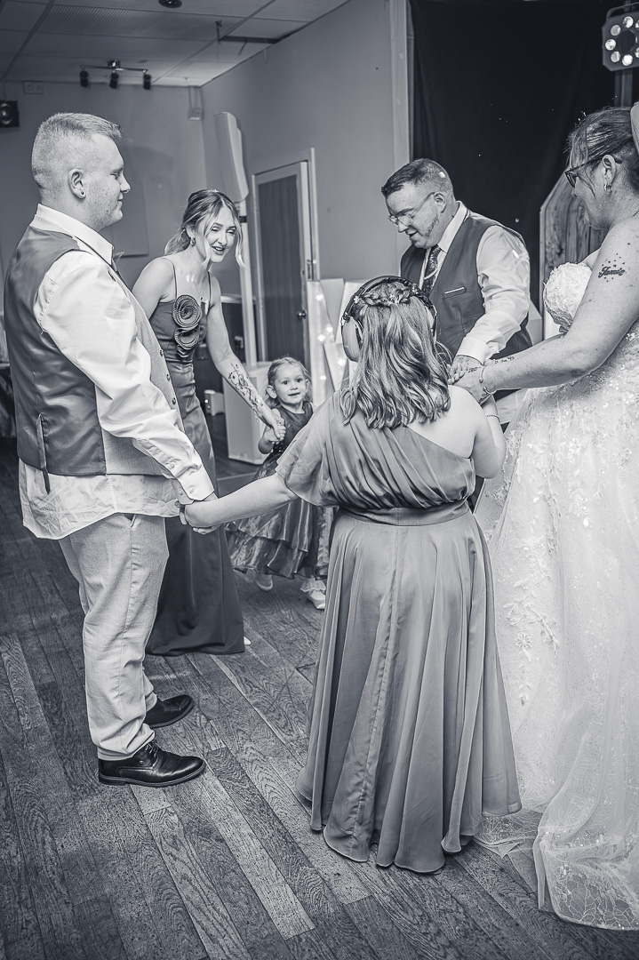 Bride, groom and their wedding party dancing on the reception dance floor at Bucks Bar