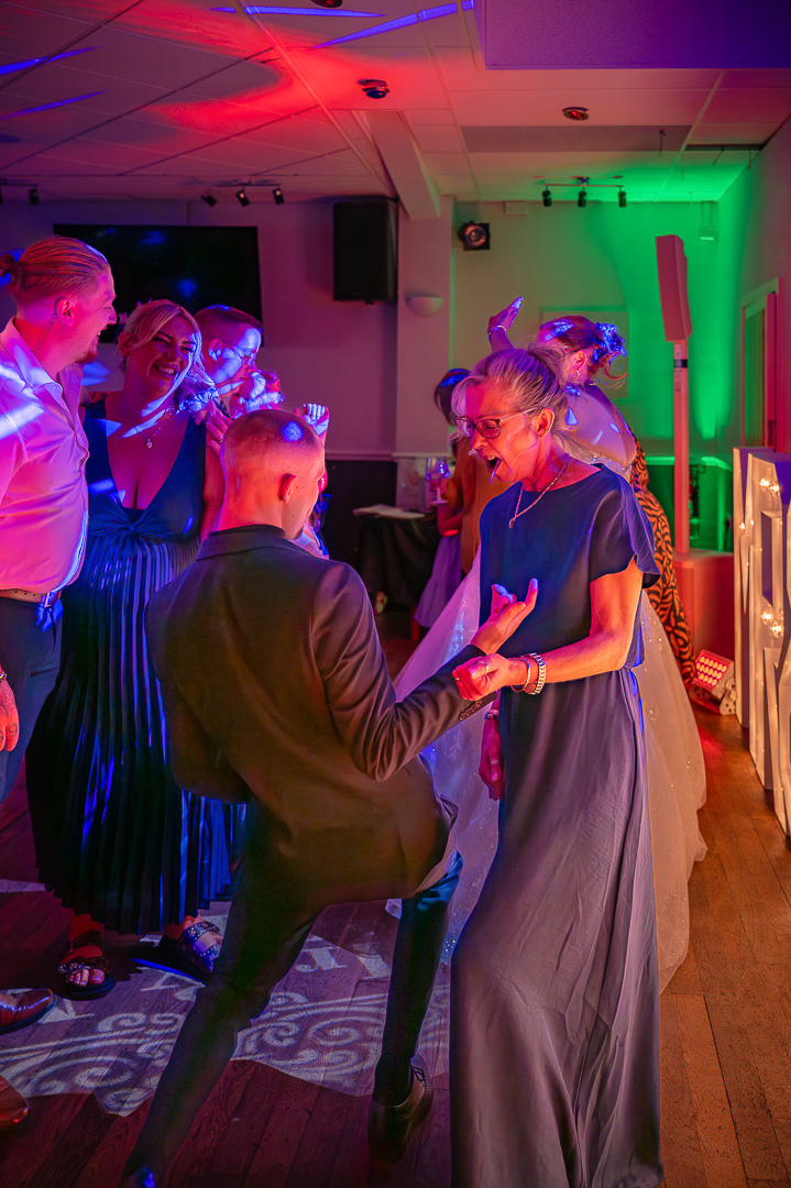 Guests dancing together on the dance floor at Bucks Bar during a joyful, traditional wedding celebration