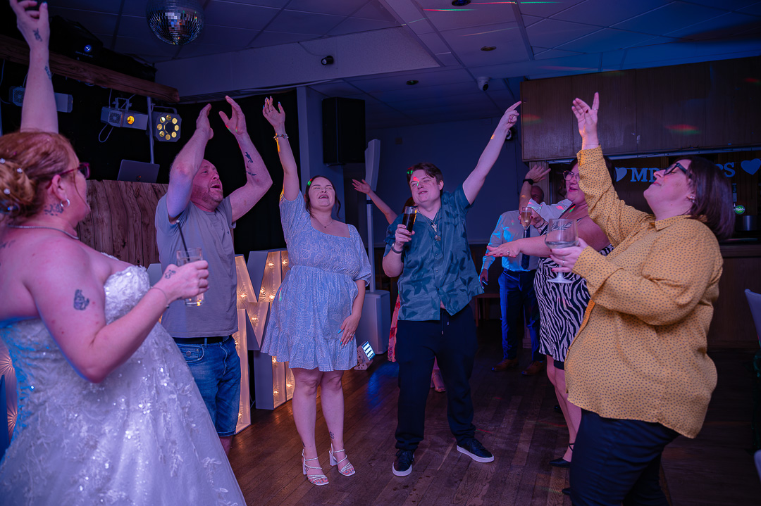 Bride dancing with wedding guests on the dance floor at Bucks Bar during a classic, traditional wedding celebration