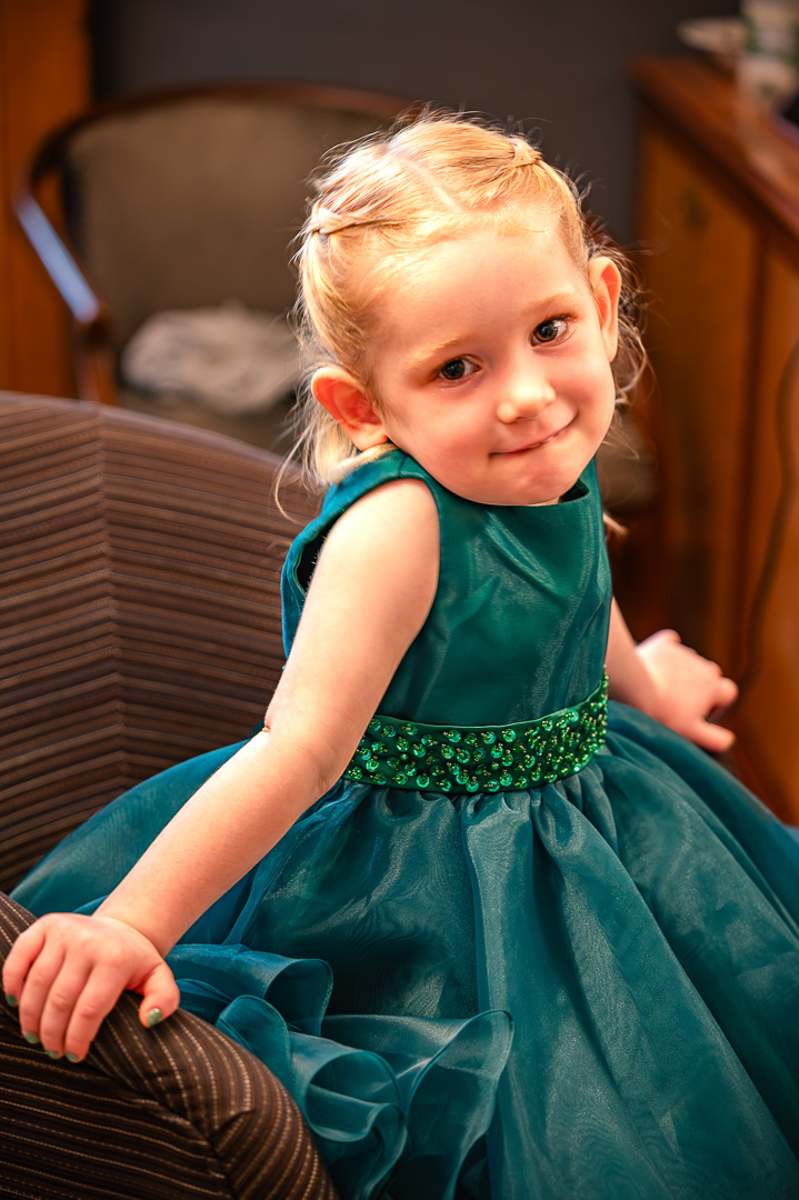 Young bridesmaid seated in her green dress during bridal preparations at the Royal Toby Hotel