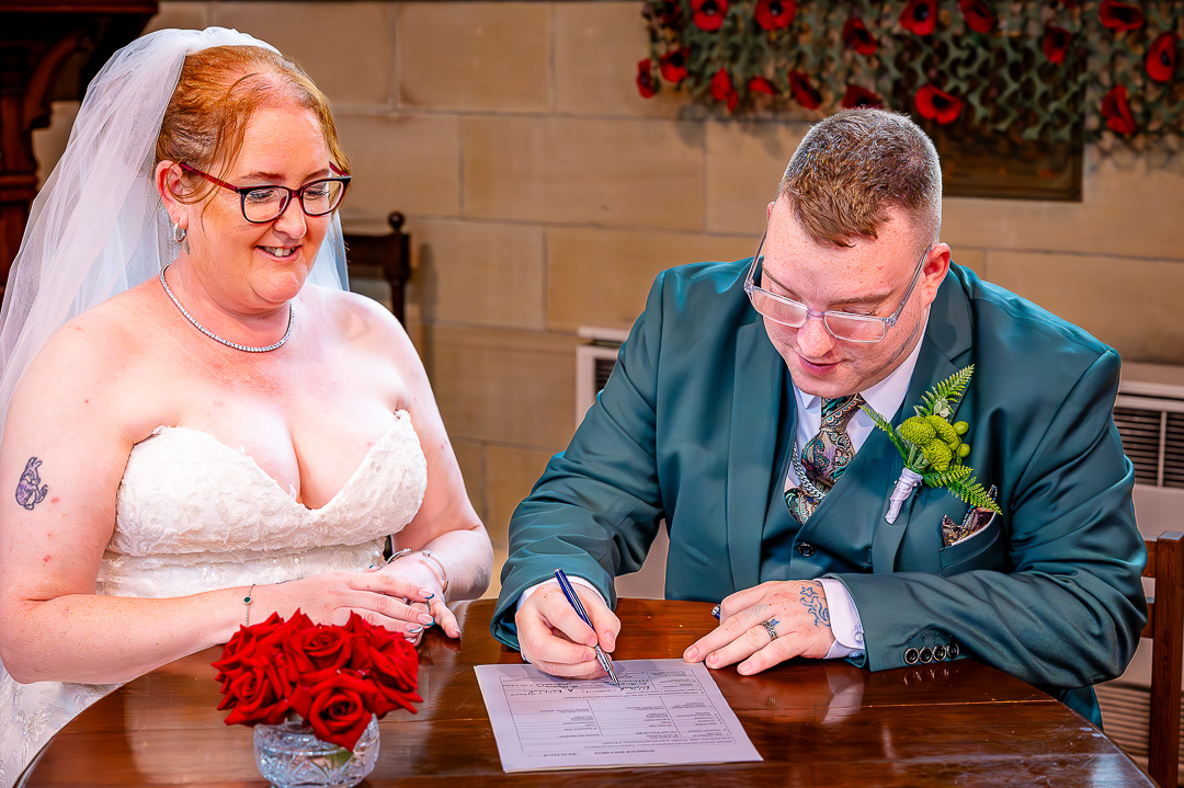Groom signing the marriage register at St Chad’s Church