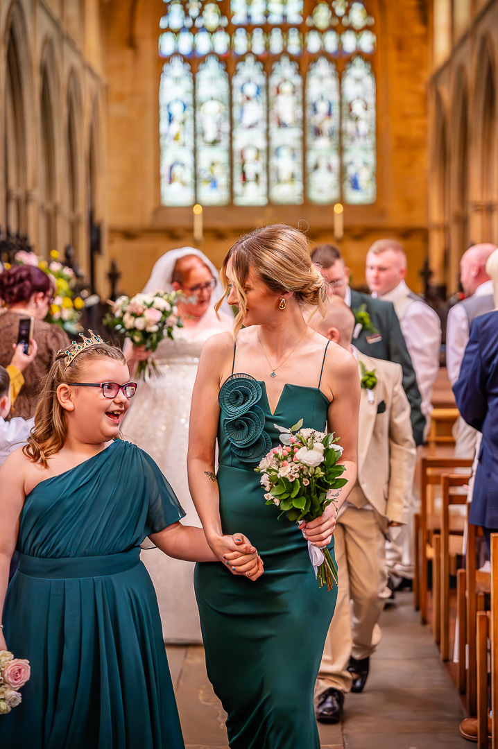Bridesmaids walking back down the aisle at St Chad’s Church