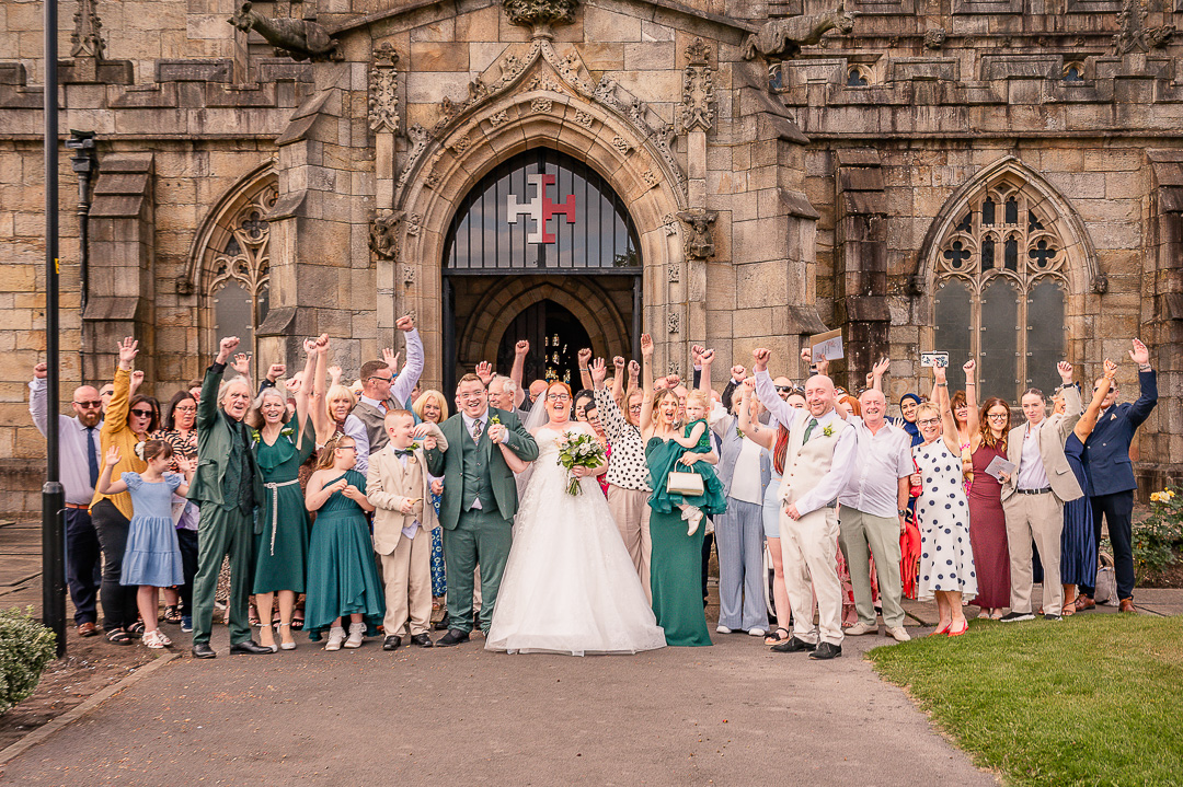 All wedding guests gathered and cheering in front of the doors of St Chad’s Church