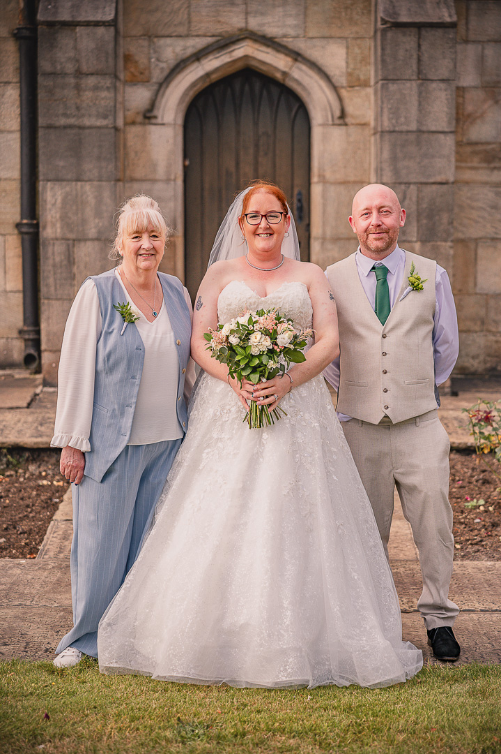 Bride with her mother and brother in front of St Chad’s Church in Rochdale