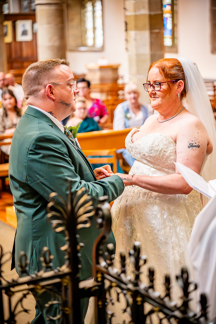 Groom placing the wedding ring on the bride’s hand during the ceremony