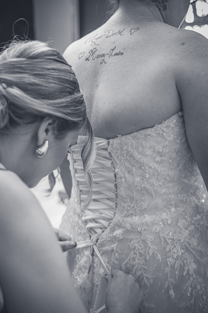 Bride’s wedding dress being fastened during preparations for the traditional Christian ceremony