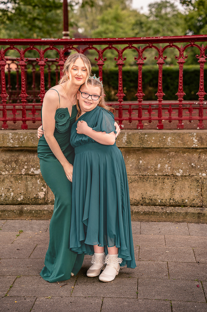 Bridesmaid and junior bridesmaid standing together in Broadfield Park
