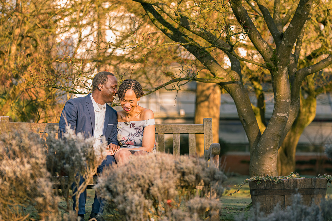 Bea and Abraham laughing during their engagement portraits in Parsonage Gardens.