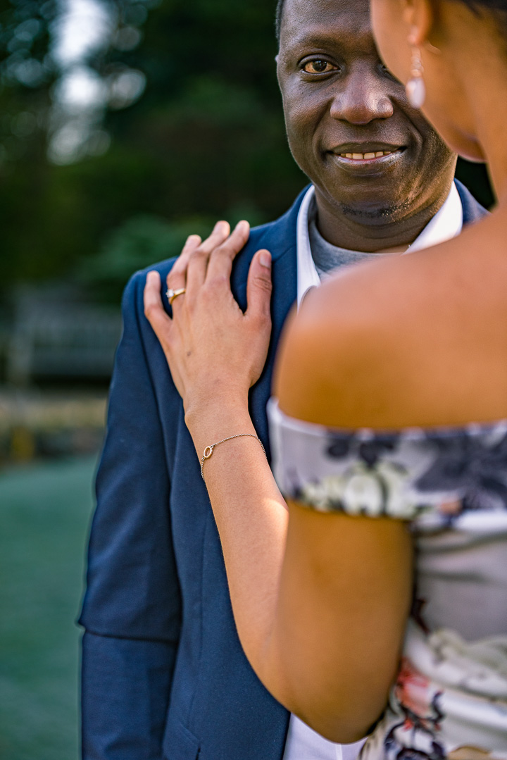 Bea resting her hand on Abraham shoulder in Parsonage Gardens engagement shoot.