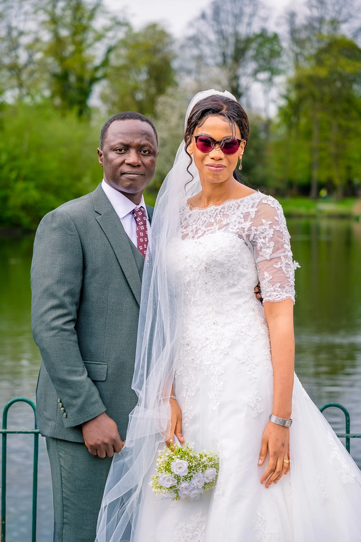 Couples portrait with lake behind them at Alexandra Park, Manchester