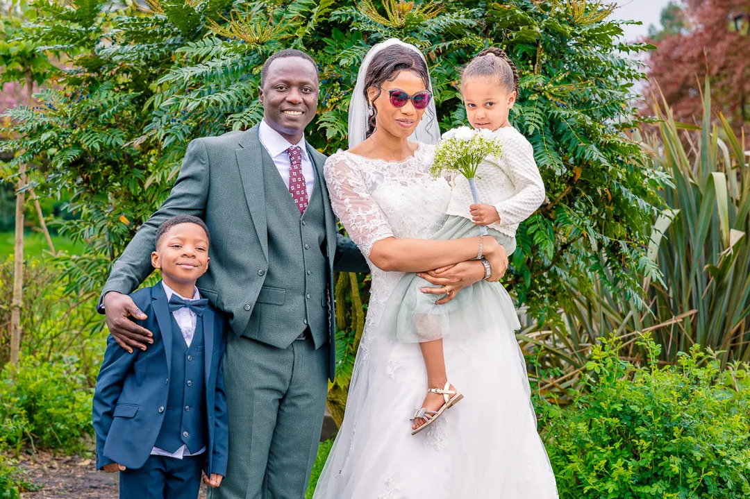 Portrait of Bride and groom with ringer bearer and flower girl at Alexandra Park, Manchester, during Bea and Abraham's wedding blessing celebrations