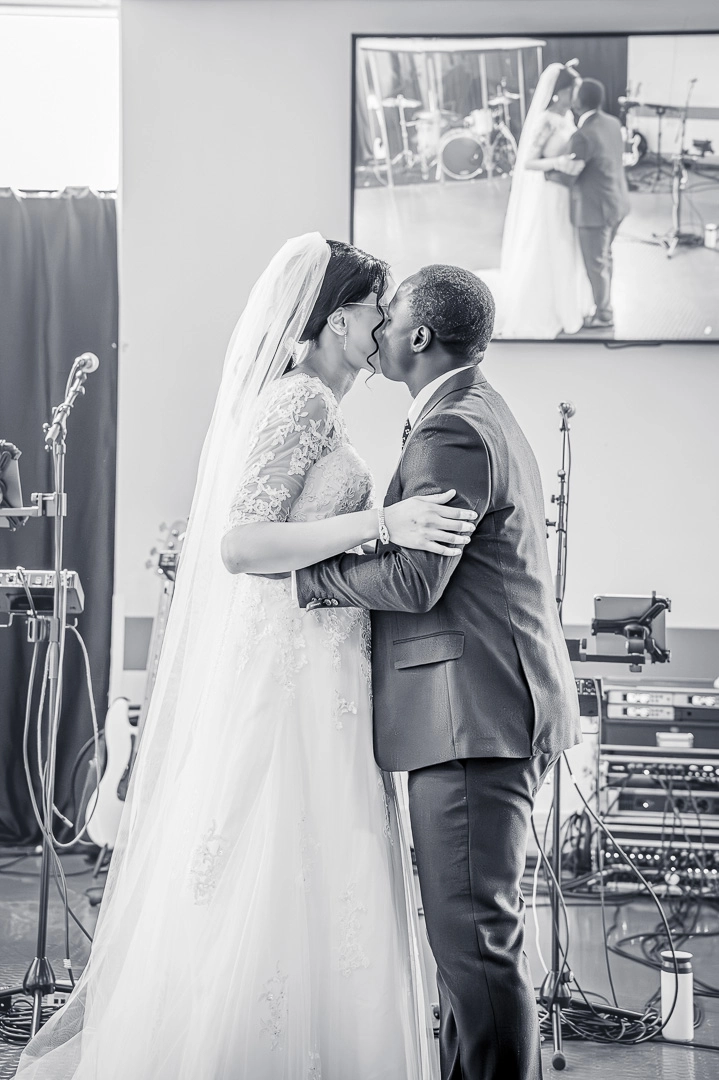Bea and Abraham sharing their first kiss during their wedding blessing at William Hulme's Grammar School, Manchester