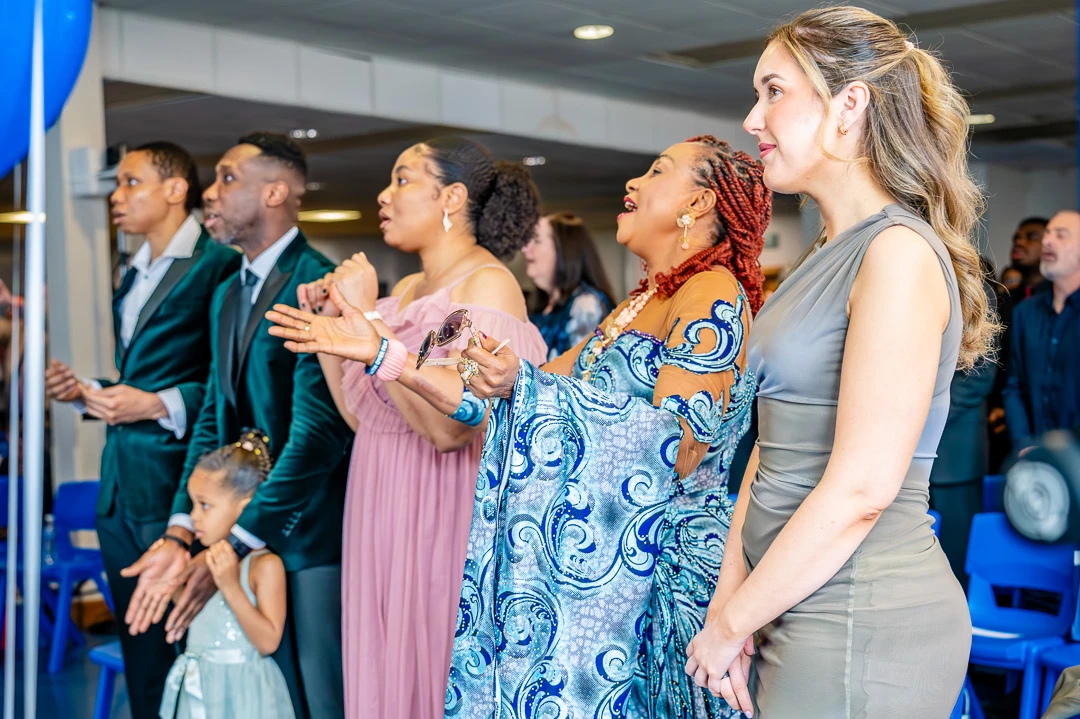 Brides family worshiping as Manchester Vineyard worship band lead worship during Bea and Abraham's wedding blessing ceremony in Manchester