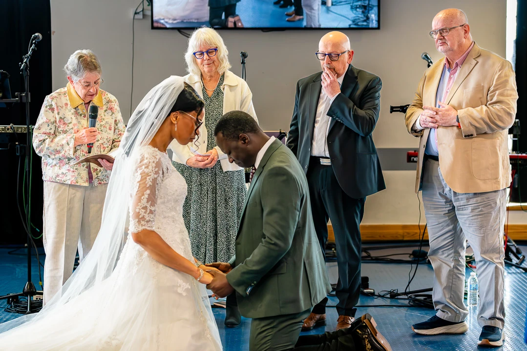 Two couples from Manchester Vineyard praying over Bea and Abraham during their wedding blessing ceremony in Manchester