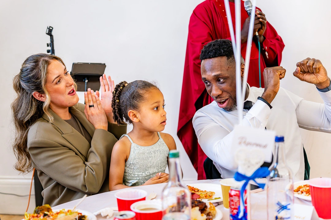 Wedding guests celebrating during wedding speech at 422 Community Hub, Ardwick