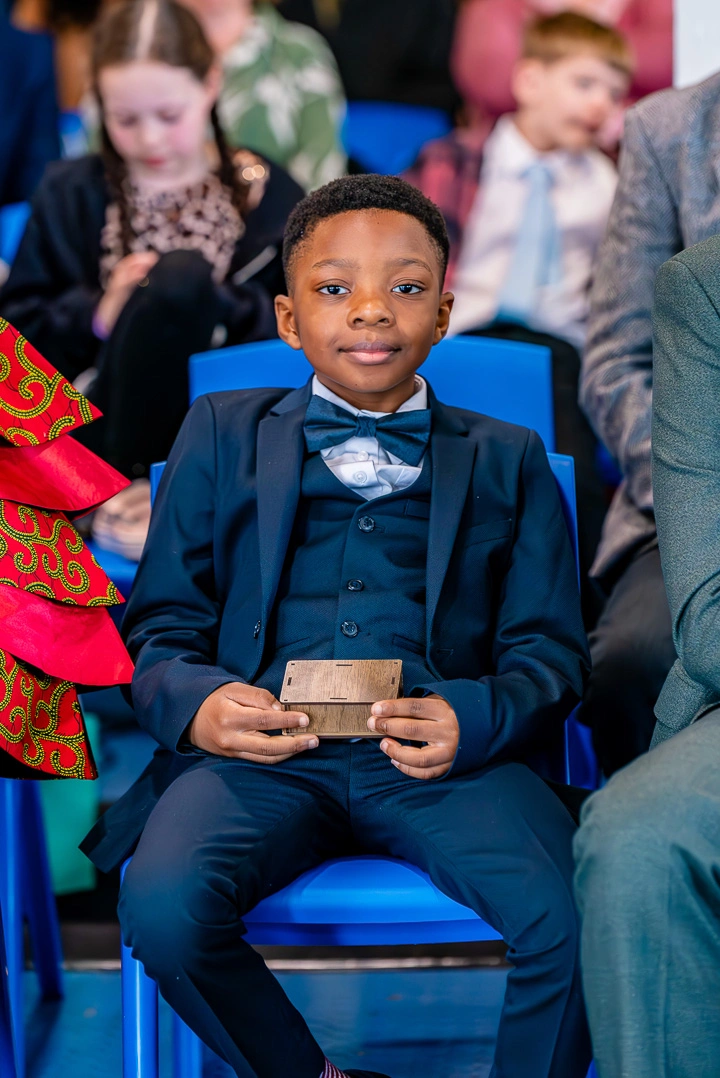 Ringer bearer proudly holding the rings at William Hulme's Grammar School, Manchester for Bea and Abraham’s Wedding Blessing