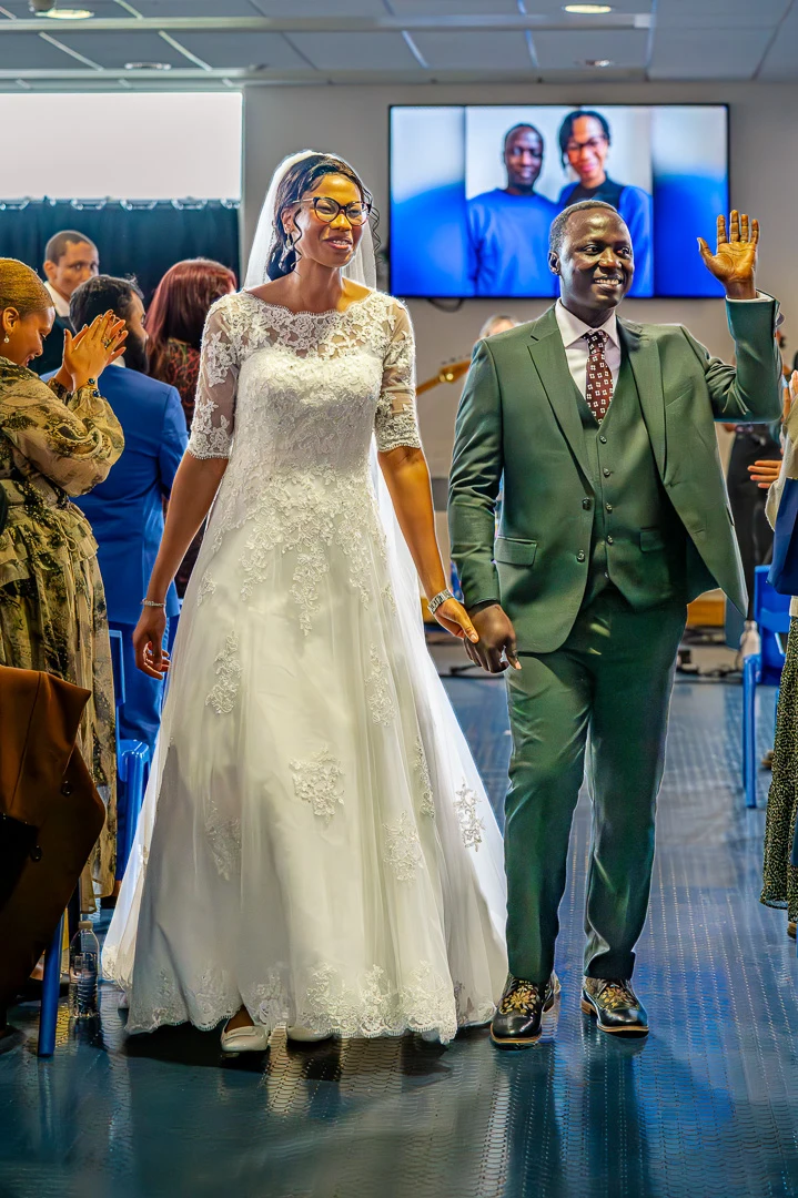 Couple celebrating as they leave thier Wedding blessing ceremony at William Hulme's Grammar School, Manchester