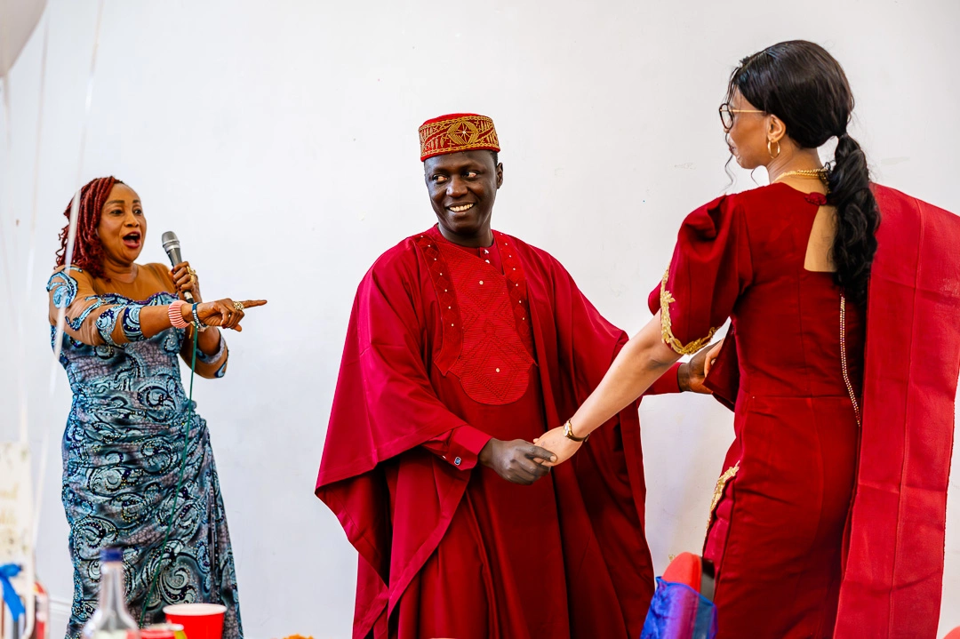 Bride and Groom dancing as Bride’s mother sings a song over them, during her wedding speech at 422 Community Hub, Ardwick, Manchester